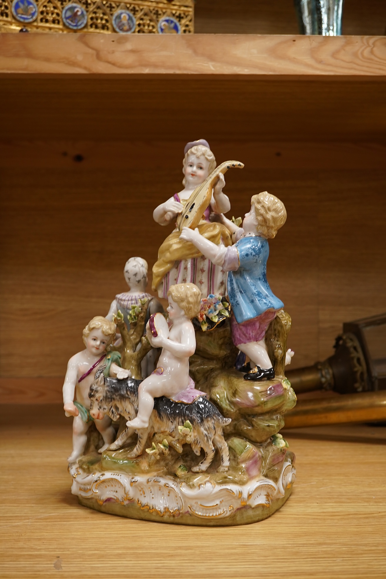 A large German porcelain group, figures playing instruments, 35cm high